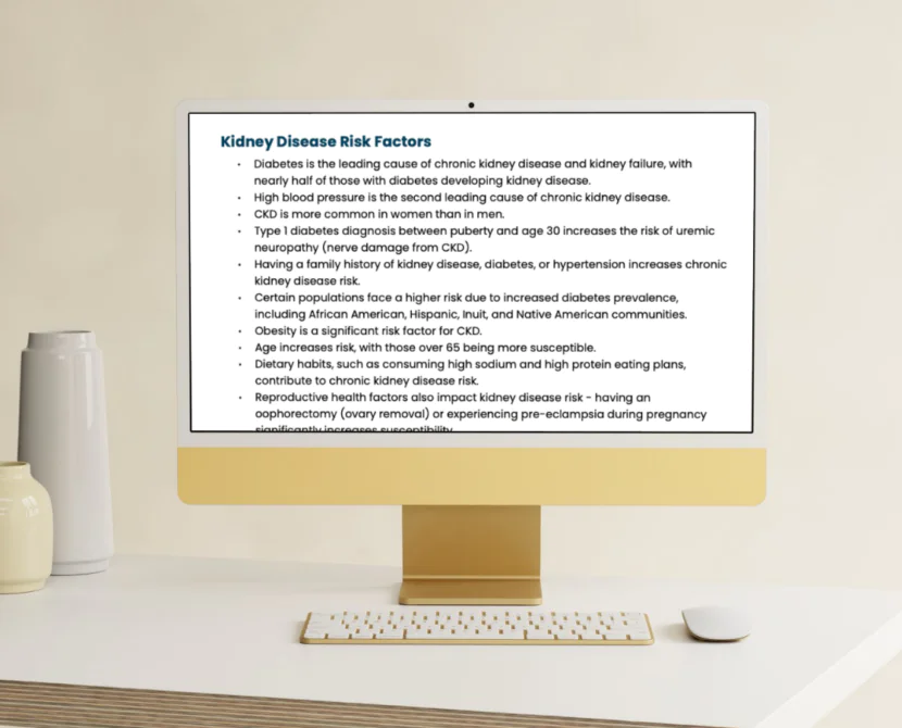 A computer monitor on a beige desk displays text about kidney disease risk factors, listing causes such as diabetes, high blood pressure, and family history. A white keyboard and mouse are on the desk.