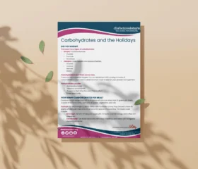 A flyer titled Carbohydrates and the Holidays from Diabetes Sisters is placed on a beige surface with leaves casting shadows. The flyer shares tips about carbohydrates, portion sizes, and managing diabetes during the holidays.
